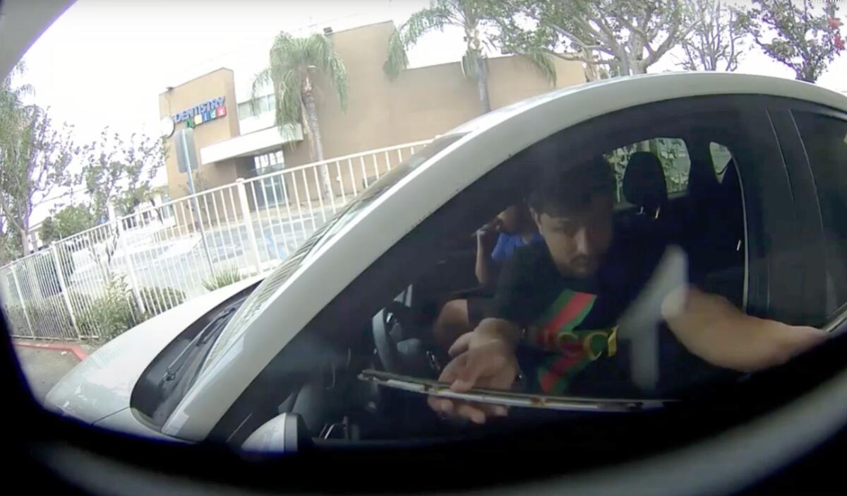 Two men in a car in an image from surveillance footage. 