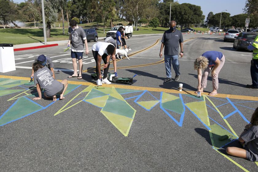 Volunteers helped paint the crosswalk at Junipero Dr. and Arlington Dr., in Costa Mesa on Saturday, Oct. 3, 2020.