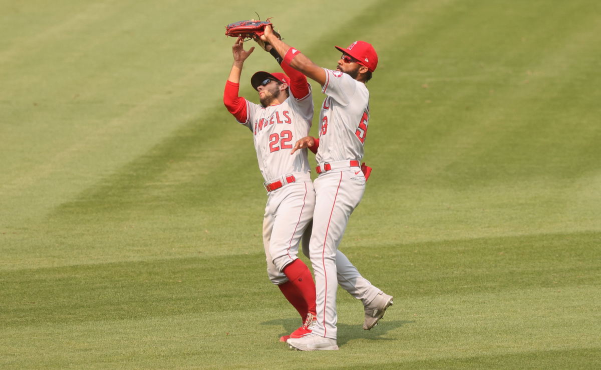 Angels second baseman David Fletcher, left, and right fielder Jo Adell collide while catching a fly ball.