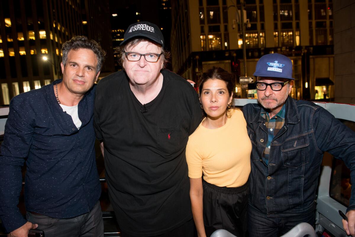Mark Ruffalo, left, Michael Moore, Marisa Tomei and Fisher Stevens were at Moore's New York protest Tuesday night.