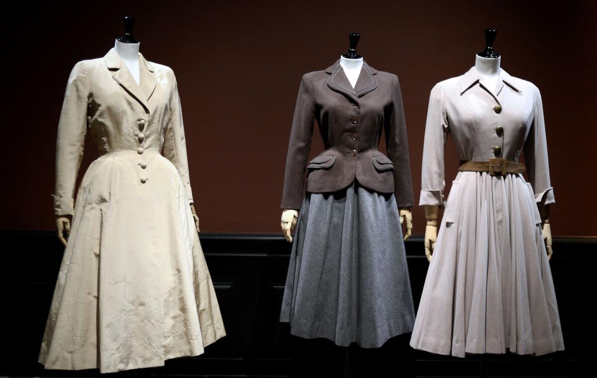 Three couture creations by fashion designers Jacques Fath, left, Jacques Heim and Christian Dior are on view at the Palais Galliera in Paris as part of an exhibition on French fashion between 1947 and 1957.