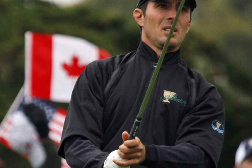 FILE - International Presidents Cup team player Mike Weir, from Canada, follows his tee shot on the par 3 second hole of his singles match against United States team player Justin Leonard at the Presidents Cup at Harding Park Golf Course, Sunday, Oct. 11, 2009, in San Francisco. Weir has been selected as the International team captain for the 2024 Presidents Cup at Royal Montreal.(AP Photo/Marcio Jose Sanchez, File)