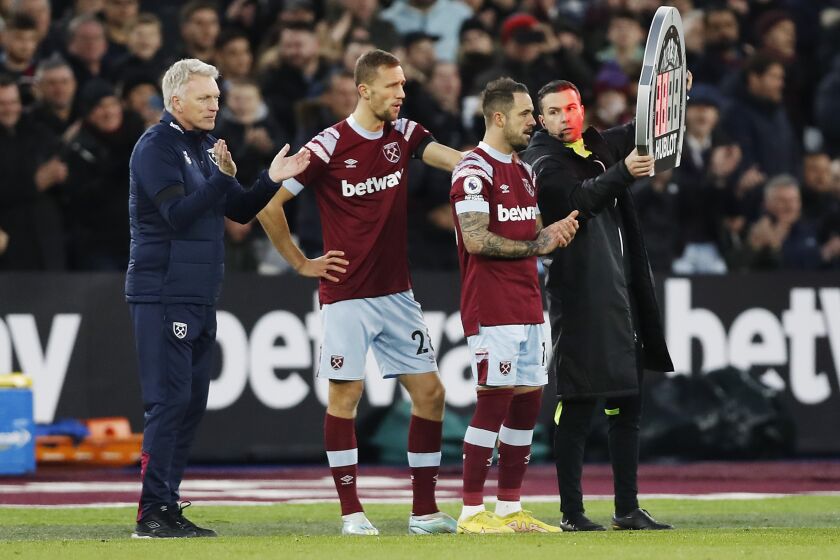 West Ham's Danny Ings prepares to run onto the pitch before being substituted on during the English Premier League soccer match between West Ham United and Everton at the London Stadium in London, Saturday, Jan. 21, 2023. This was Danny Ings' debut appearance with West Ham United. (AP Photo/Steve Luciano)