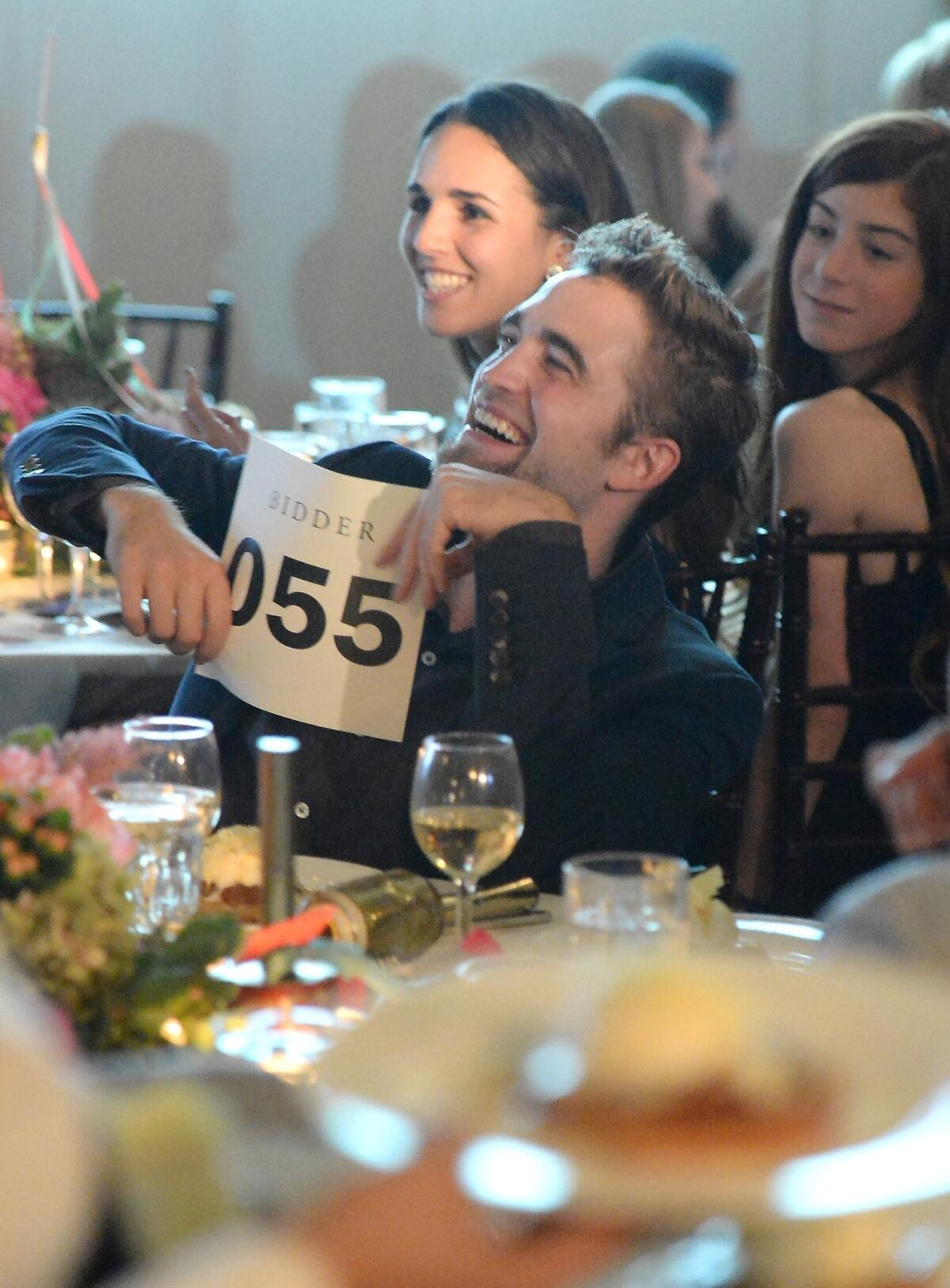 Robert Pattinson bids during the 6th Annual GO GO Gala at Bel-Air Bay Club on Thursday.