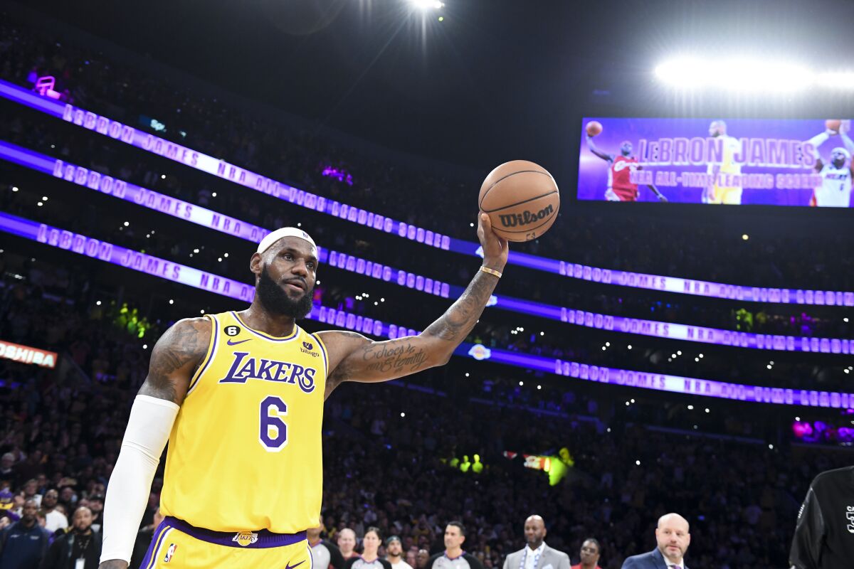 LeBron James celebrates breaking Lakers legend Kareem Abdul-Jabbar's NBA all-time scoring record.