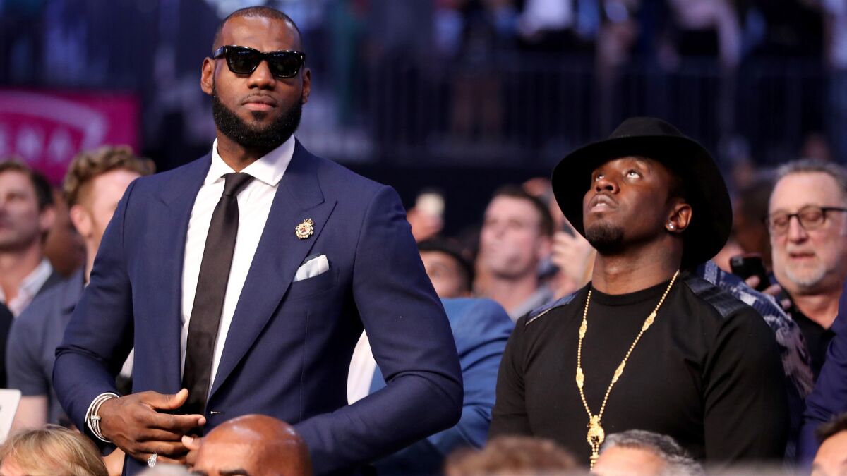 LeBron James, left, and Sean Combs were among the celebrities at the Floyd Mayweather Jr.-Conor McGregor fight on Saturday at T-Mobile Arena.