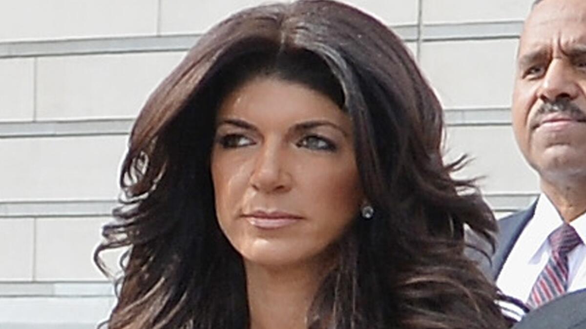 Teresa Giudice leaves federal court in Newark, N.J., in March. On Thursday, "The Real Housewives of New Jersey" star was sentenced to 15 months in prison and her husband was got 41 months on fraud and conspiracy charges.
