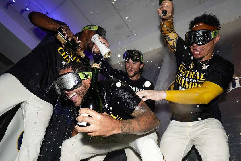 Milwaukee Brewers' Freddy Peralta is doused as the Brewers celebrate after clinching the NL Central, after a baseball game against the St. Louis Cardinals on Tuesday, Sept. 26, 2023, in Milwaukee. (AP Photo/Morry Gash)