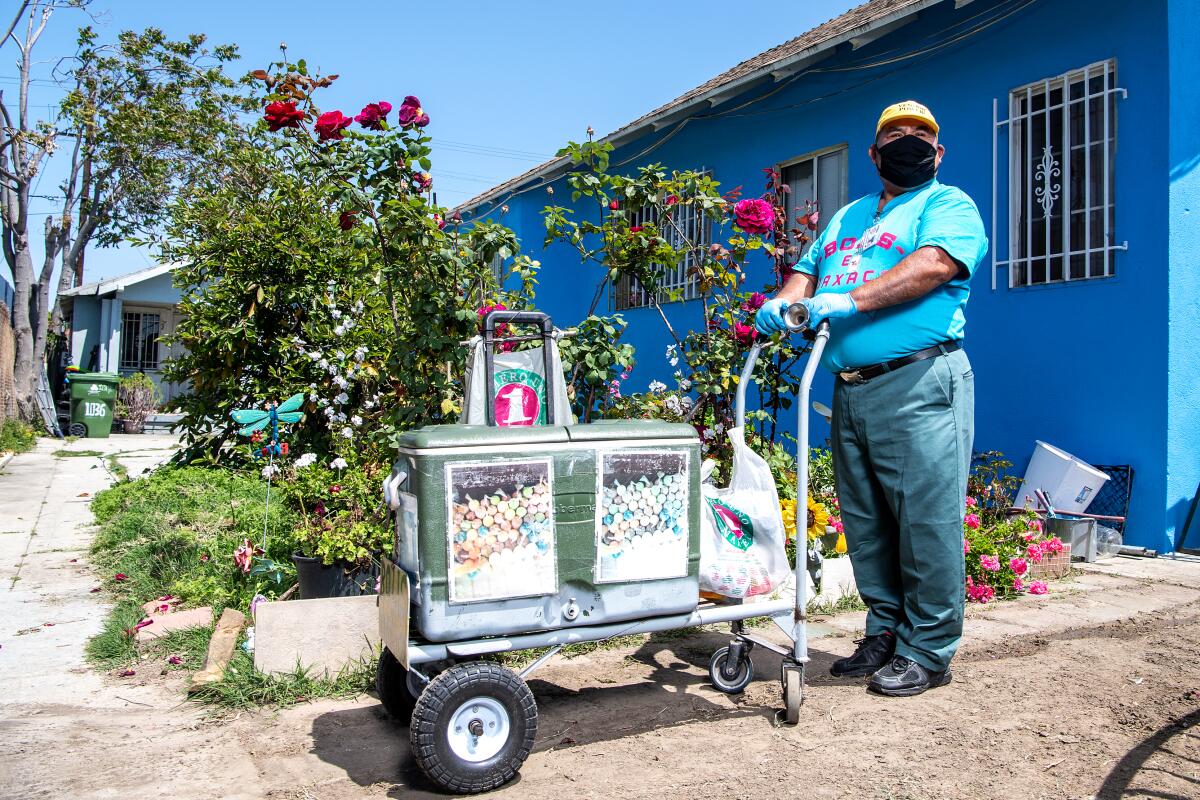 Faustino Martinez with his pushcart outside his South L.A. neighborhood.