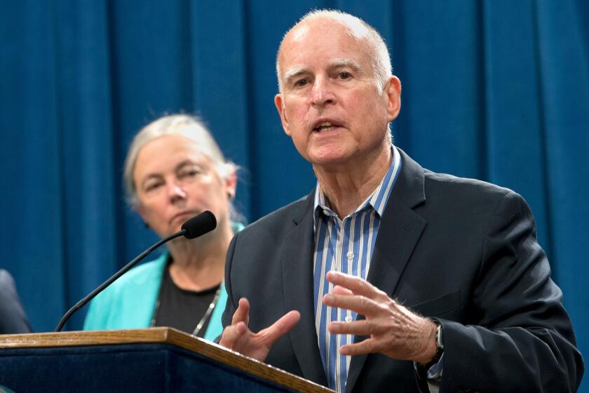 Gov. Jerry Brown talks with reporters about new climate legislation approved by lawmakers Wednesday.