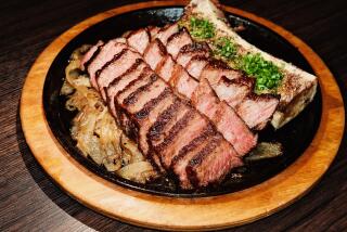 A photo of sliced zabuton steak with bone marrow on a skillet at Danbi restaurant in Koreatown.