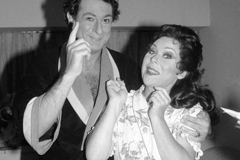 FILE - Tenor Placido Domingo, left, appears with soprano Renata Scotto in a backstage dressing room prior their opening night performance of Vincenzo Bellini's "Norma" at the Metropolitan Opera House in New York on Sept. 22, 1981. Scotto, a soprano of uncommon intensity who became a successful director after her singing career, died Wednesday in her hometown of Savona, Italy. She was 89. (AP Photo/Elizabeth Richter, File)