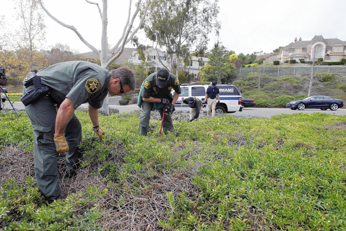 Orange County law enforcement officers search for a weapon and evidence after the Feb. 9 shootings at the Sachses' home.