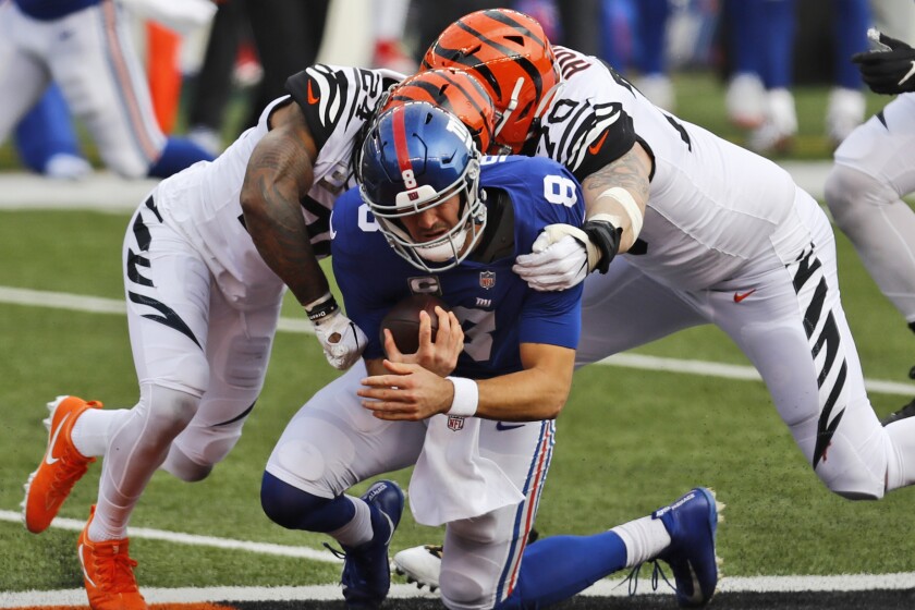 Cincinnati Bengals strong safety Vonn Bell and defensive end Margus Hunt sack New York Giants quarterback Daniel Jones.