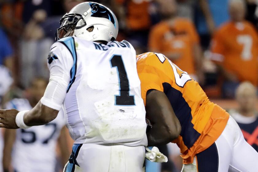 Panthers quarterback Cam Newton recoils as he takes a head-to-head hit from Broncos safety Darian Stewart on Sunday.