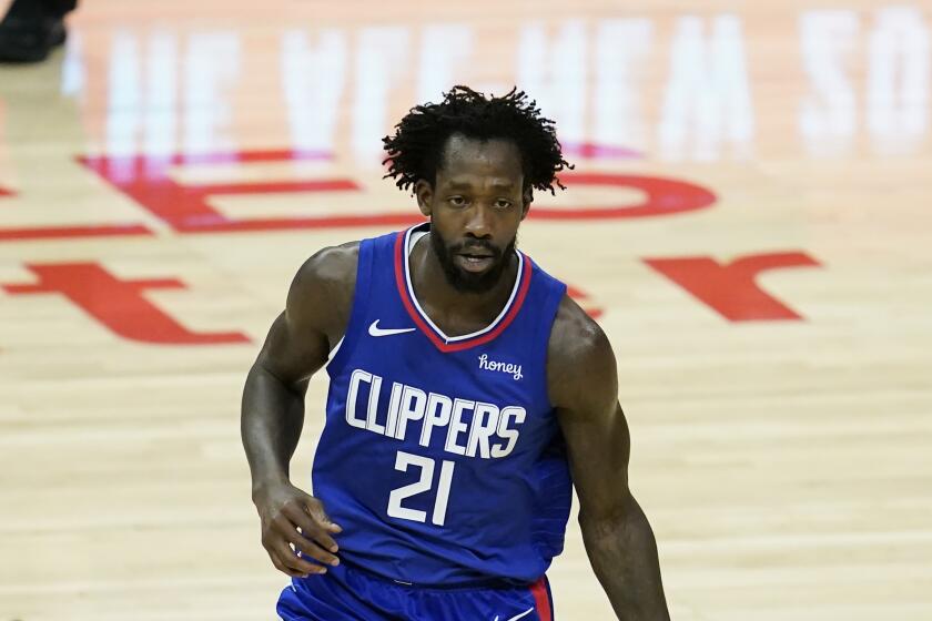 Los Angeles Clippers guard Patrick Beverley (21) controls the ball during the first quarter of an NBA basketball game against the Sacramento Kings Wednesday, Jan. 20, 2021, in Los Angeles. (AP Photo/Ashley Landis)