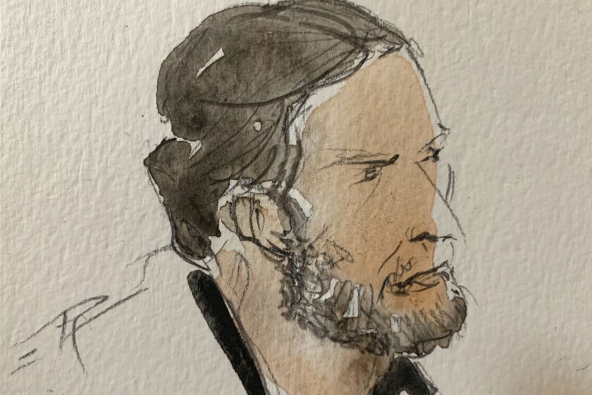 This courtroom sketch shows key defendant Salah Abdeslam, in the special courtroom built for the 2015 attacks trial, Wednesday, Sept. 8, 2021 in Paris. The trial of 20 men accused in the Islamic State group's coordinated attacks on Paris in 2015 that transformed France opened Wednesday in a custom-built complex embedded within a 13th-century courthouse. (Noelle Herrenschmidt via AP)
