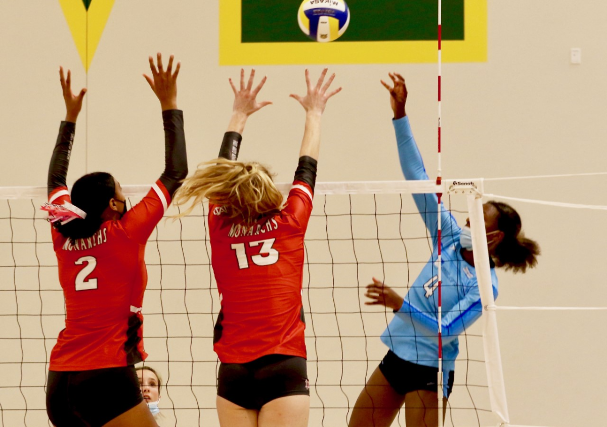 Mater Dei's Isabel Clark, left, and Amber Thompson jump up to block in front of Marymount's Torrey Stafford.