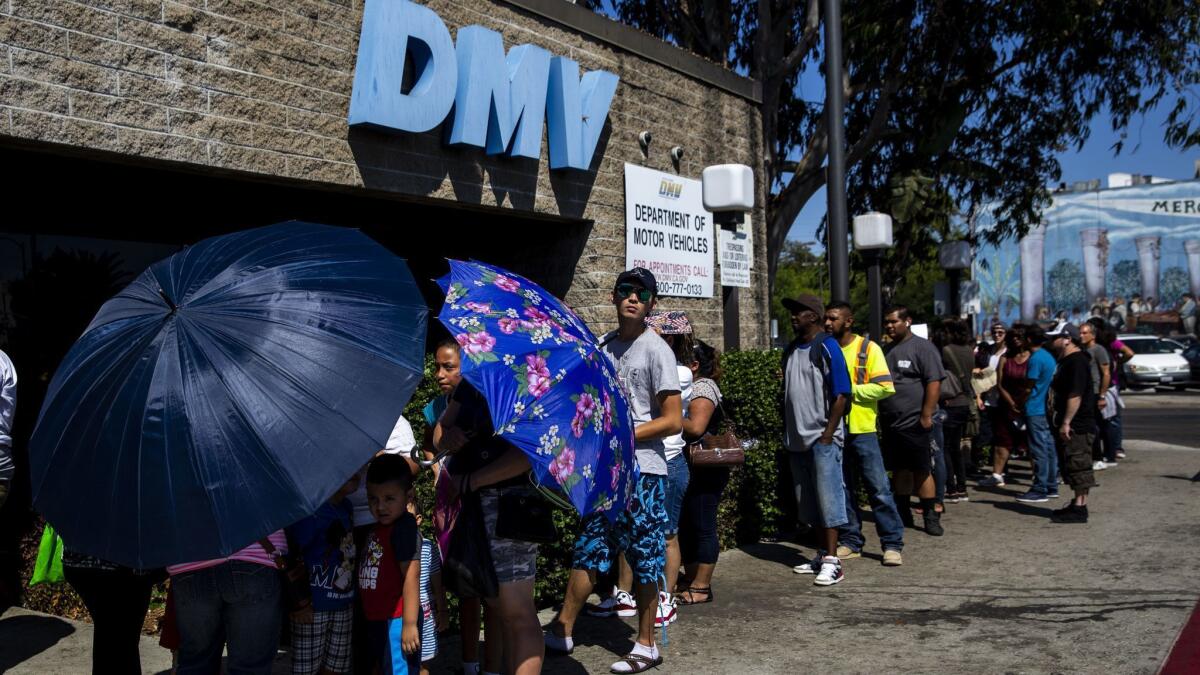 A line of people stretches around a California Department of Motor Vehicles building in South L.A. on Tuesday.