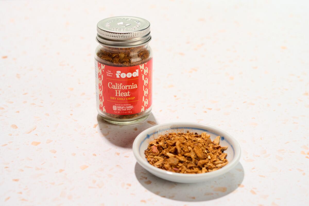 A jar of California Heat spice mix next to a small dish of the spice mix