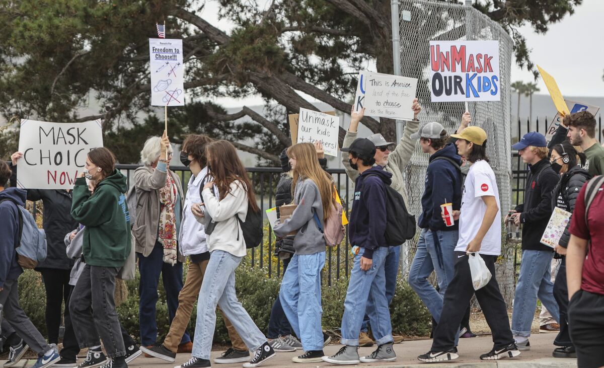 Parents and supporters protest school mask mandates in front of San Marcos High School on Tuesday, Feb. 22.