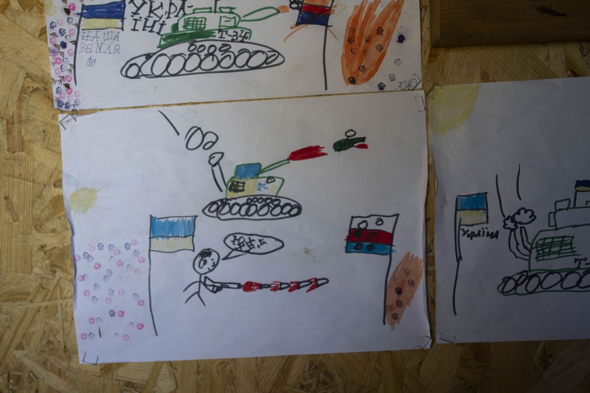 Drawings made by Ukrainian children decorate a sleeping area in a Ukrainian trench near the front lines in the Donetsk region, eastern Ukraine, Wednesday, June 8, 2022. (AP Photo/Bernat Armangue)