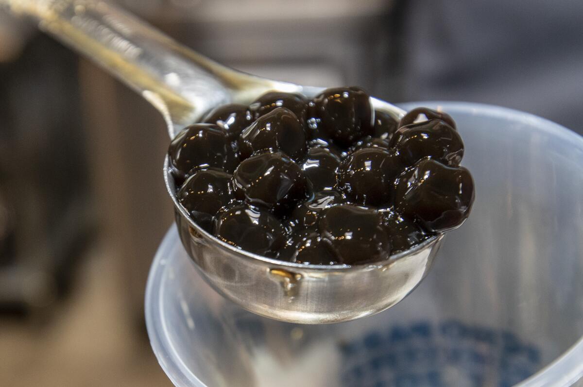 A scoop of small black tapioca balls