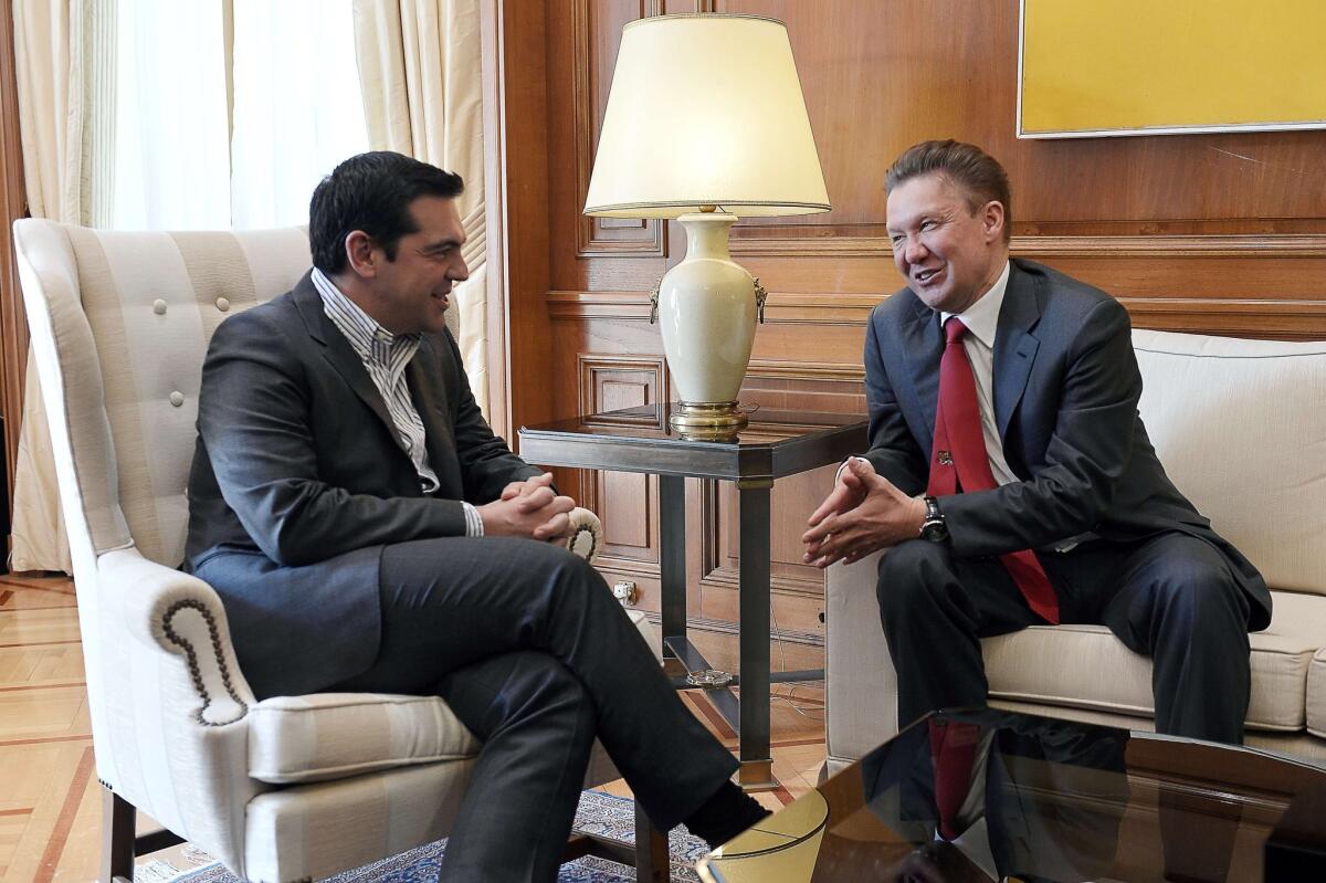 Greek Prime Minister Alexis Tsipras, left, speaks to Alexei Miller, chief executive of Russian energy gas giant Gazprom, during a meeting in Athens on April 21.