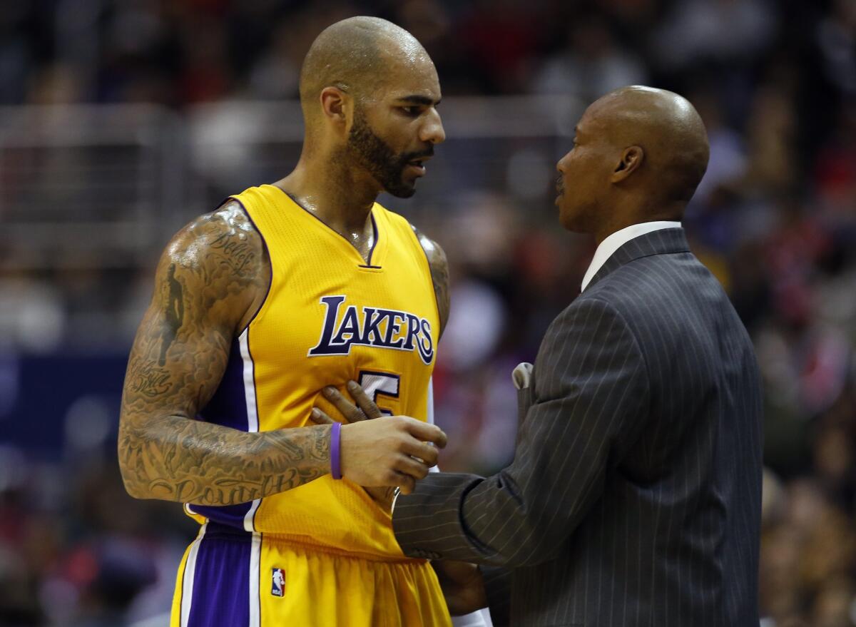 Lakers forward Carlos Boozer talks with Coach Byron Scott during a Dec. 3 game against the Washington Wizards.