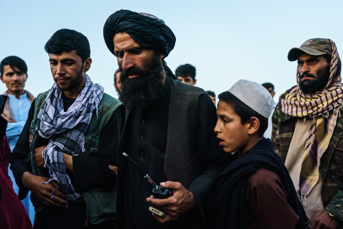 Taliban fighters gather at a rally in Kampani area in the outskirts of Kabul