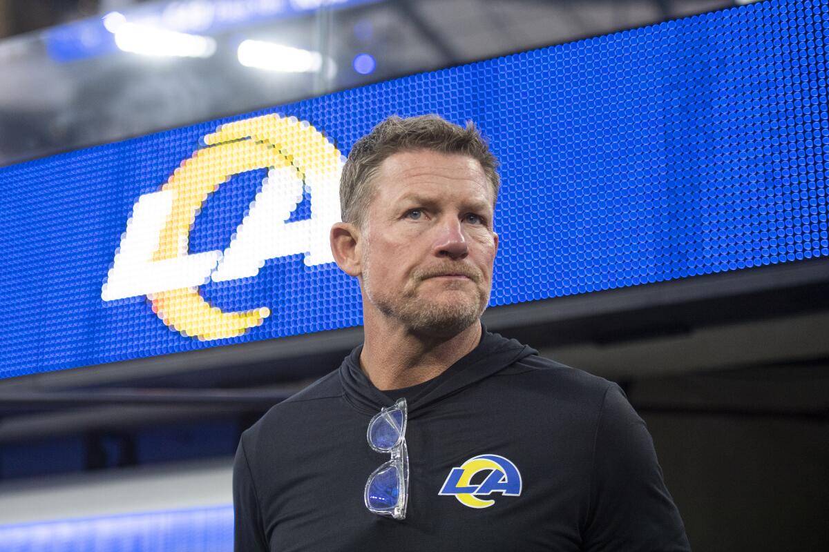 Rams general manager Les Snead walks onto the field before a game.