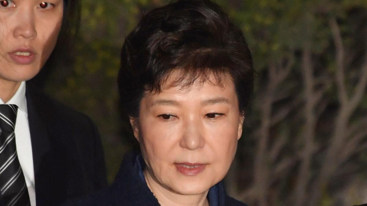 Ousted South Korean President Park Geun-hye leaves after a hearing on a prosecutors' request for her arrest at the Seoul Central District Court on March 30, 2017.