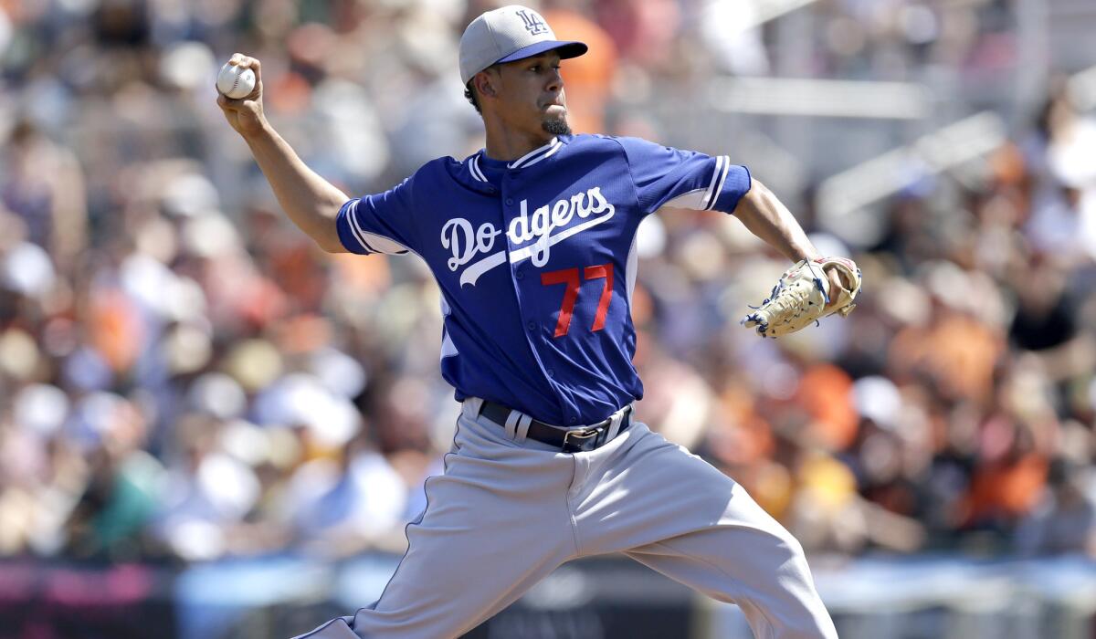 Dodgers pitcher Carlos Frias works against the Giants during an exhibition game in Scottsdale, Ariz., on March 29.