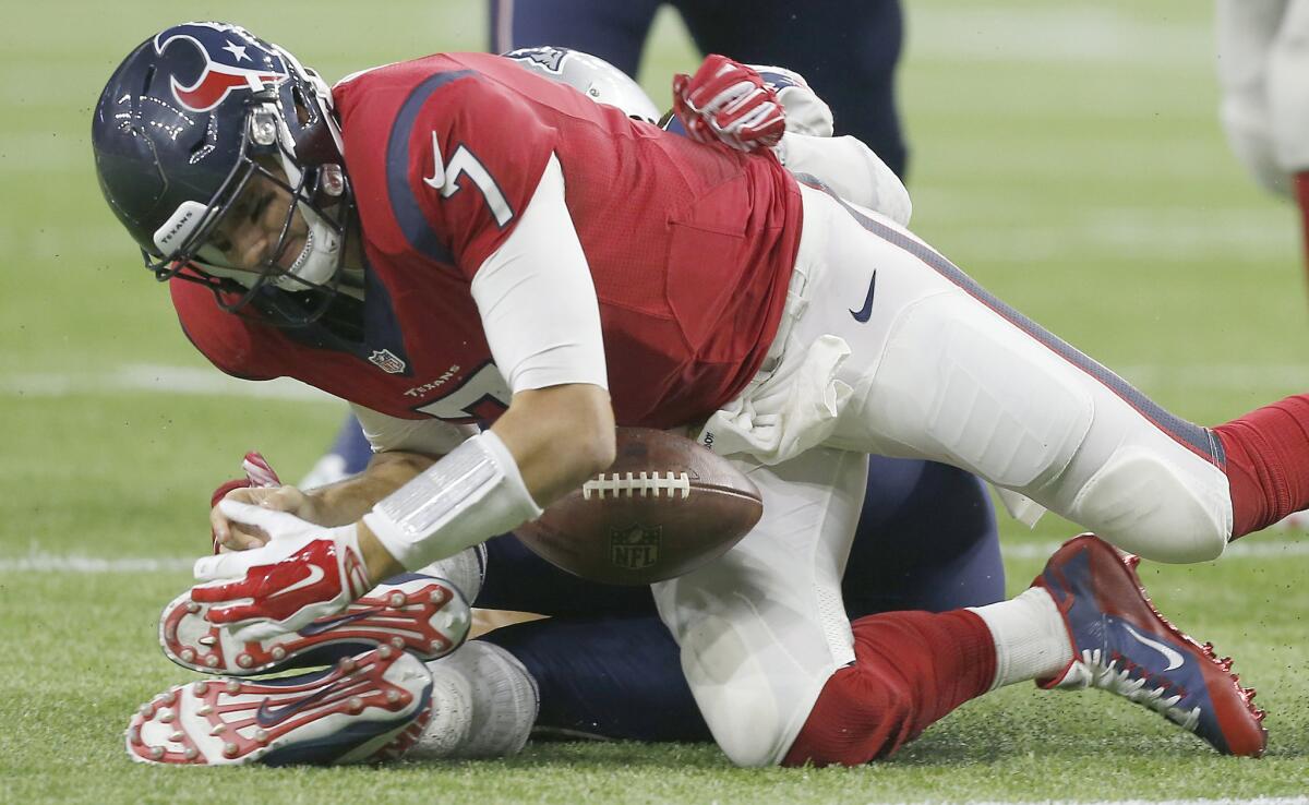 Texans quarterback Brian Hoyer fumbles the ball while being sacked by Patriots defensive lineman Jabaal Sheard in the fourth quarter.