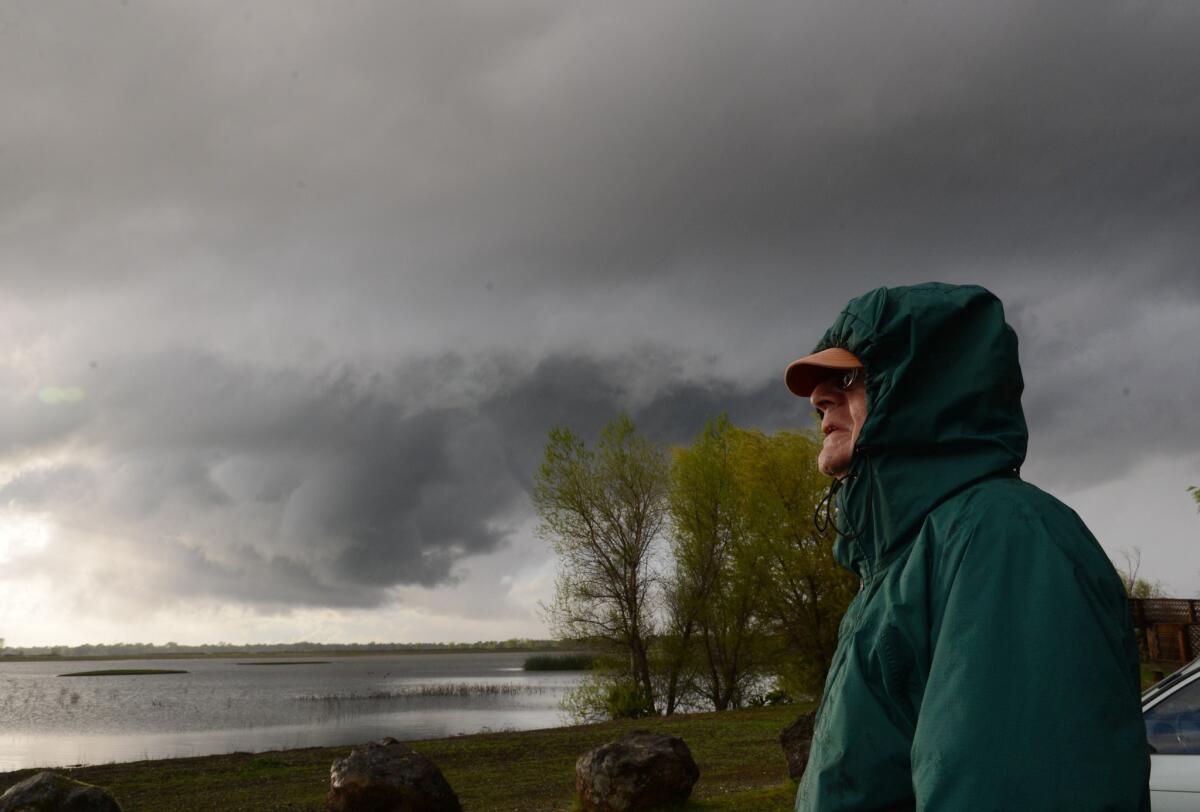 Larry Crisman watches clouds swirl over the Sacramento River Wildlife Refuge during a severe storm that included a report of a tornado touchdown.