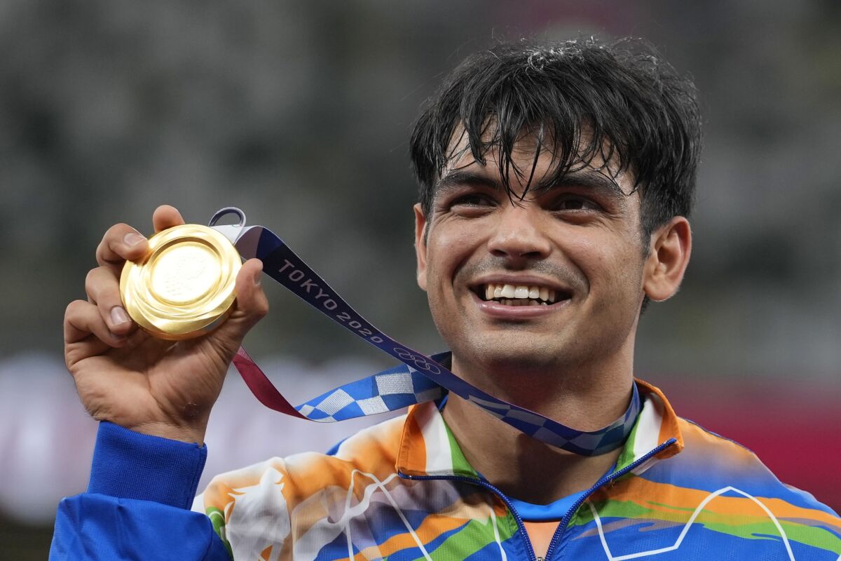 FILE - Gold medalist Neeraj Chopra, of India, poses during the medal ceremony for the men's javelin throw at the 2020 Summer Olympics, Saturday, Aug. 7, 2021, in Tokyo. In India, there's a wave of kids picking up the javelin. They all want to be the next Neeraj Chopra, who became the country's first Olympic champion in track and field during the Tokyo Games. (AP Photo/Martin Meissner, File)