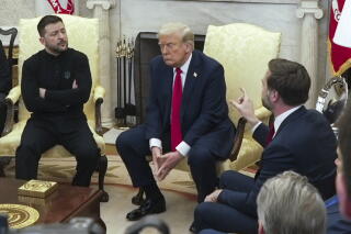 JD Vance speaks with Volodymyr Zelensky as Donald Trump listens in the Oval Office.