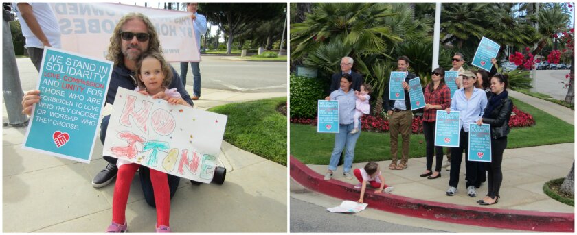Ben Hogan and daughter Leia, left, were part of a larger group of sign-wielding protesters, right, that gathered in front of the Beverly Hills Hotel on Saturday morning to protest new anti-gay laws in Brunei.