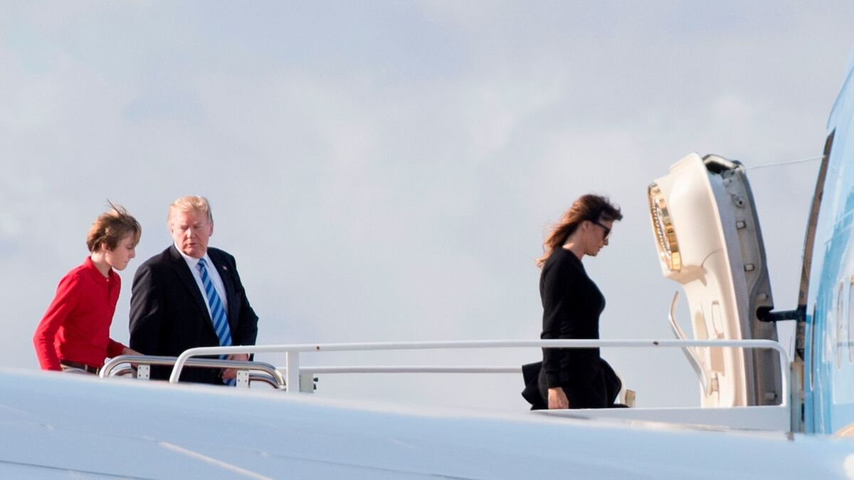 President Trump, son Barron and First Lady Melania Trump board Air Force One at Palm Beach International Airport on Feb. 19.