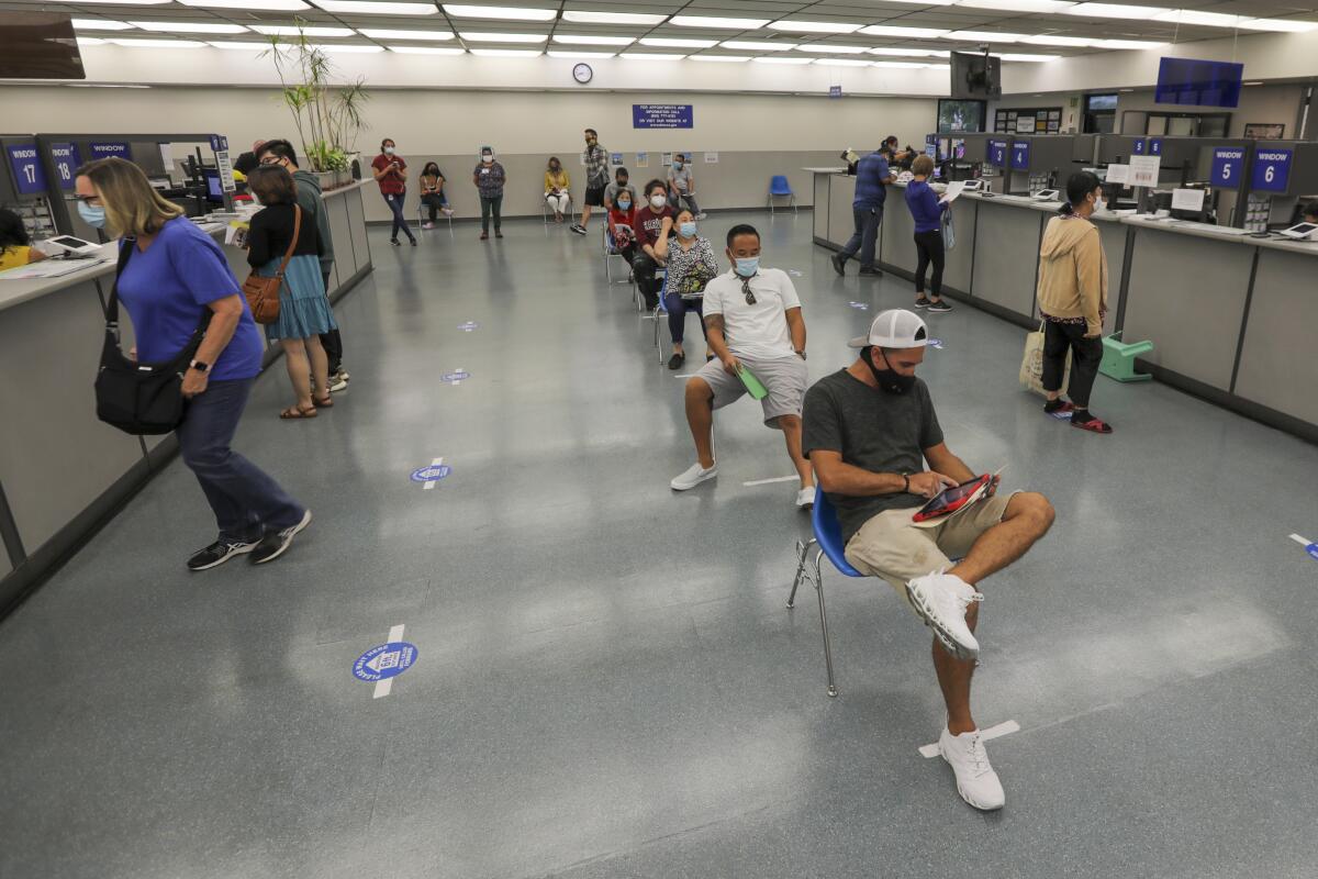 People wait in line at the DMV