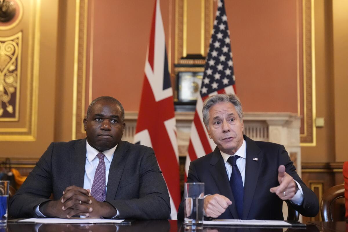 Secretary of State Antony Blinken, right, gestures as he participates with Britain's Foreign Secretary David Lammy