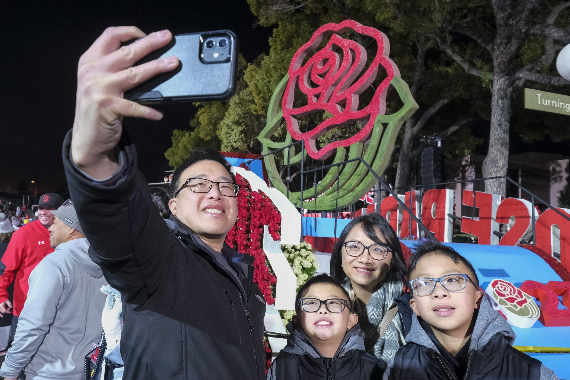 The Yee family takes a selfie in front of a float ahead of Monday's 134th Tournament of Rose Parade.