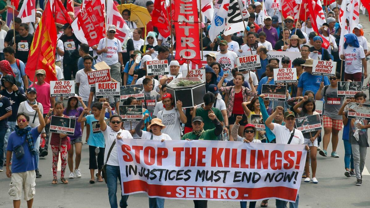 Protesters in Manila on May 1 carry a mock coffin to protest the continuing killings under Philippine President Rodrigo Duterte's war on drugs.