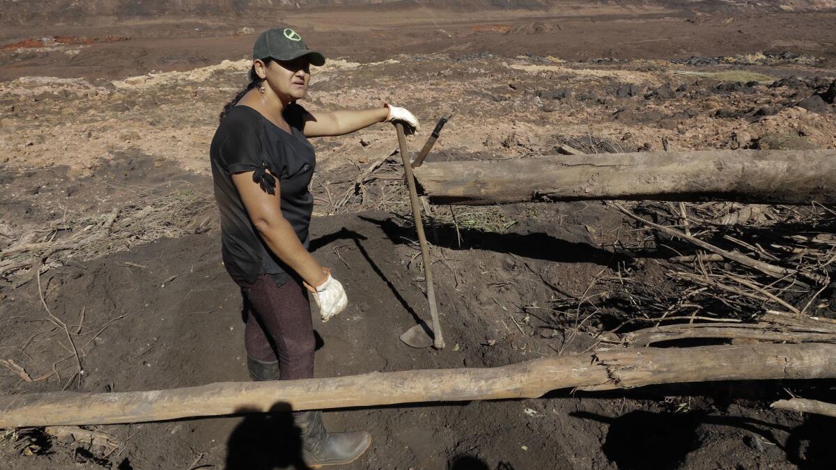 Tereza Ferreira Nascimento dug in search of the body of her missing brother days after a mining company's waste dam collapsed in Brumadinho, Brazil.