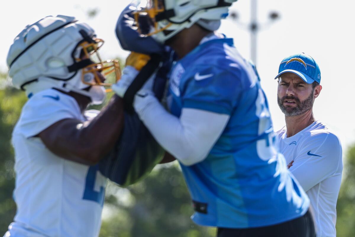 Chargers coach Brandon Staley watches special teams drills during training camp in July.