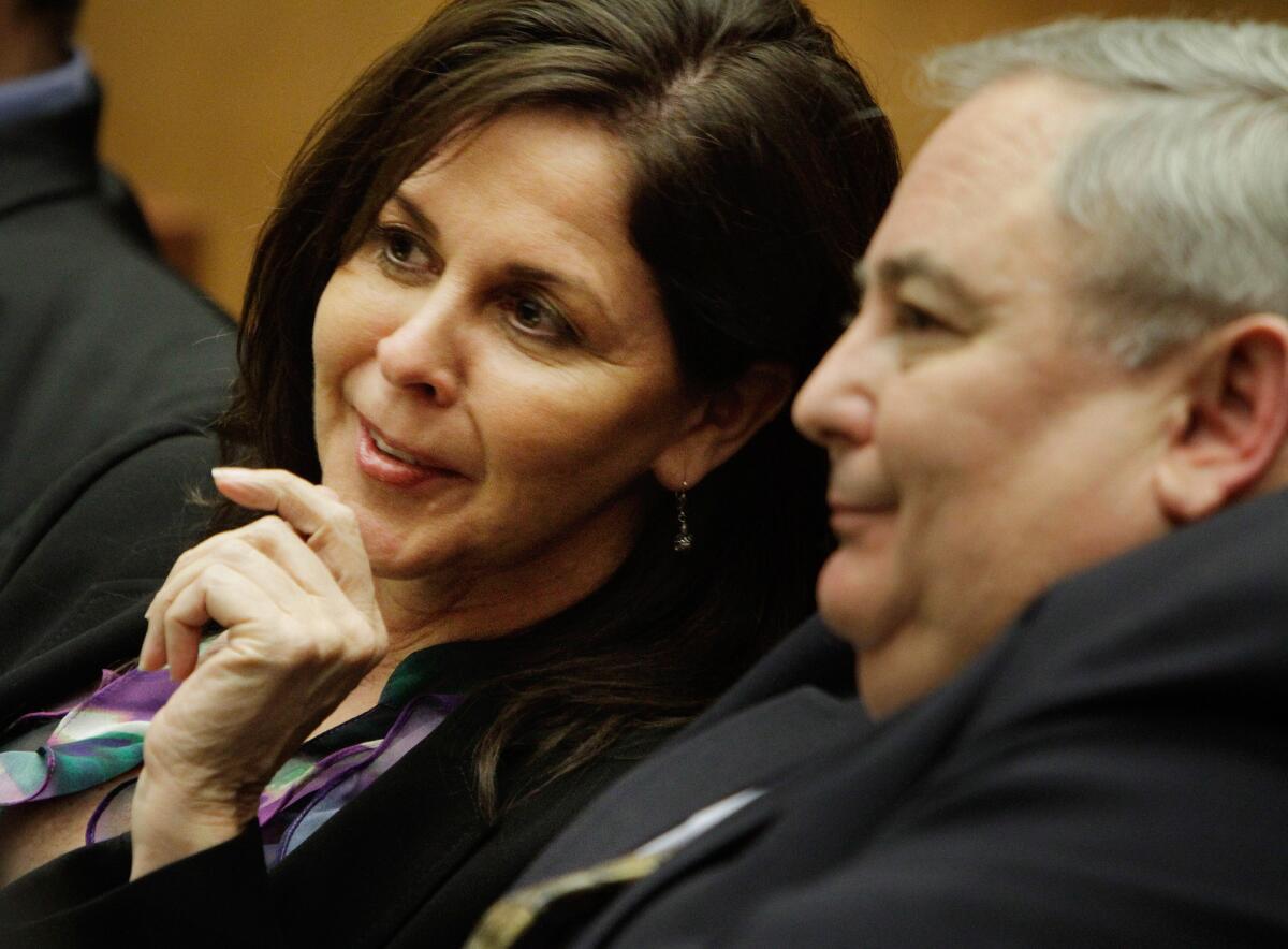Former Bell assistant City Administrator Angela Spaccia confers with her former boss, Robert Rizzo.