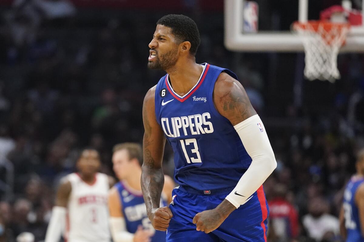 Clippers forward Paul George reacts after making a 3-pointer against the Rockets in Los Angeles Monday.