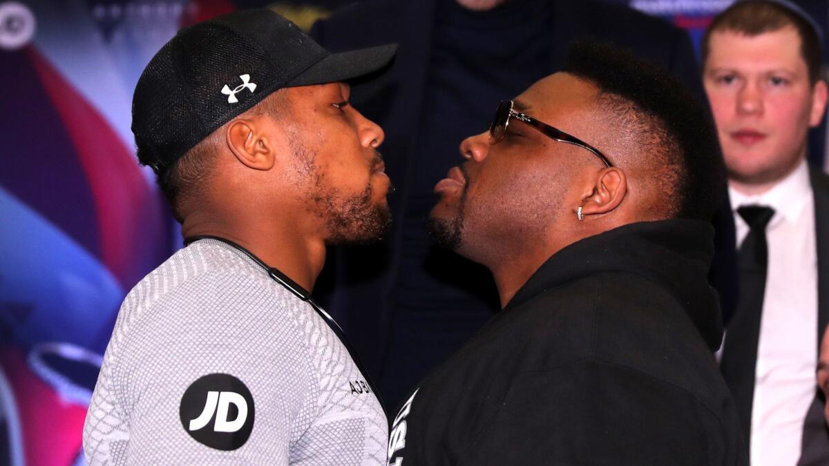 Anthony Joshua, left, and Jarrell "Big Baby" Miller stare each other down during a Feb. 25 news conference in London.