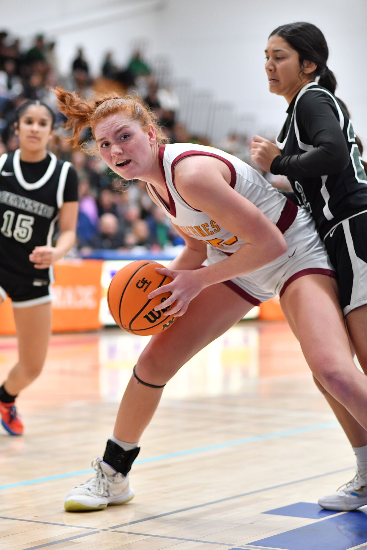 Senior Laura Rucks looks to move the ball against Pirate defenders.
