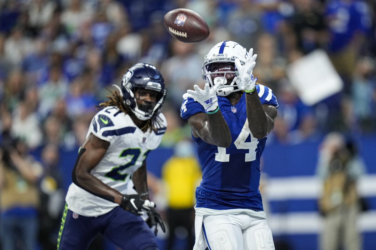 Indianapolis Colts wide receiver Zach Pascal (14) makes catch for a touchdown in front of Seattle Seahawks cornerback Tre Flowers (21) during the second half of an NFL football game in Indianapolis, Sunday, Sept. 12, 2021. (AP Photo/AJ Mast)